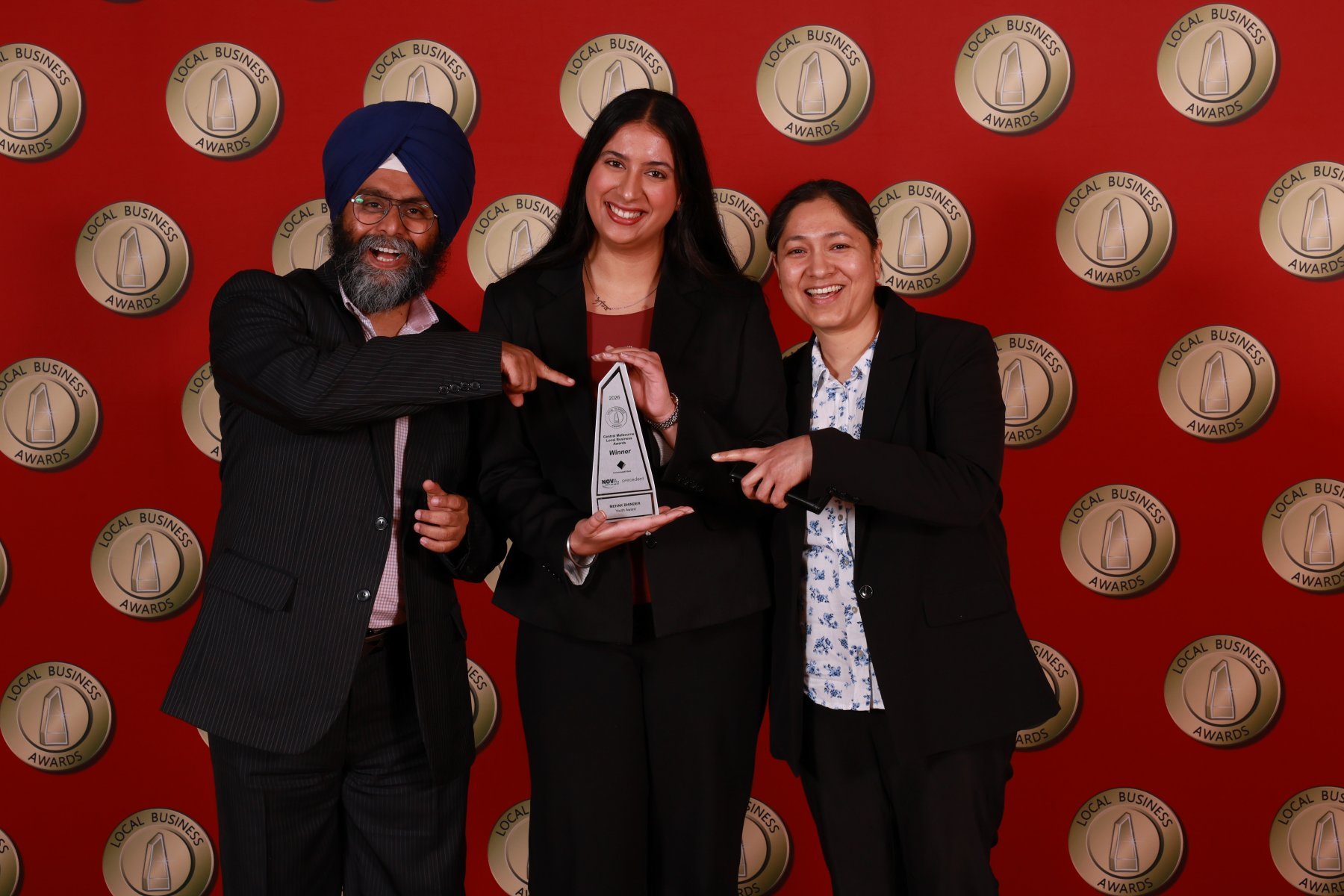 Dr Indramohan Singh, Mehak Bhinder and Parvinder Kaur celebrating with the 2026 Local Business Awards trophy